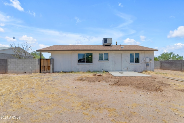 rear view of property with central AC unit