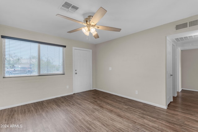 empty room featuring ceiling fan and dark hardwood / wood-style floors