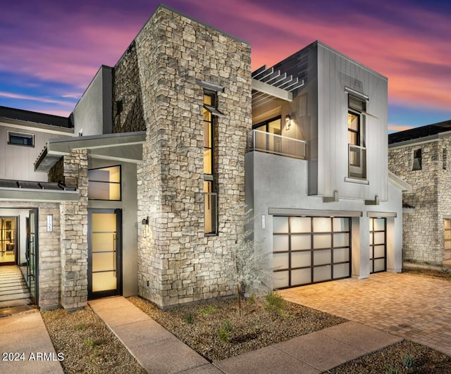 contemporary home with a balcony and a garage