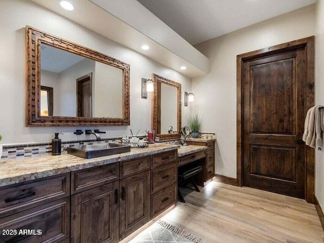 bathroom featuring vanity and hardwood / wood-style floors