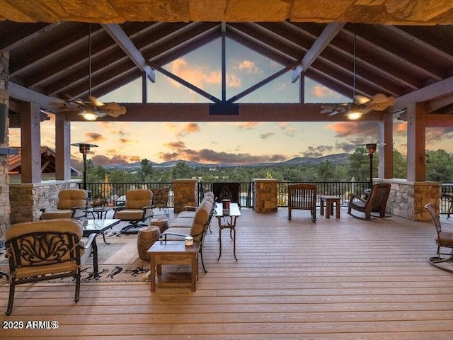 deck at dusk with a gazebo and a mountain view