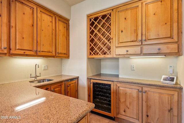 kitchen featuring wine cooler, sink, and light stone counters