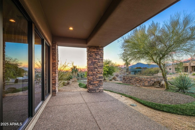 view of patio terrace at dusk