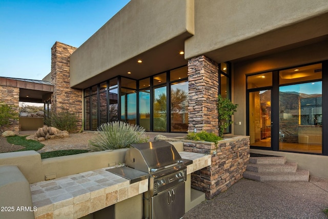 view of patio featuring area for grilling and exterior kitchen