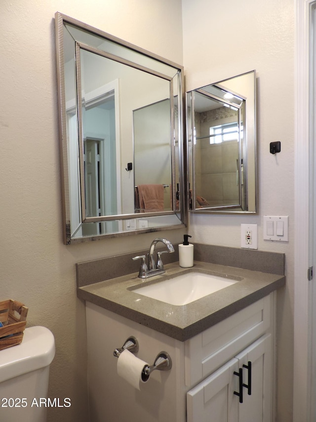 bathroom featuring vanity and toilet