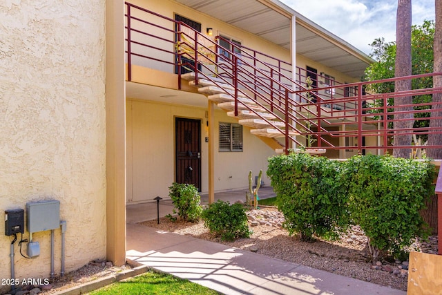 entrance to property with stucco siding