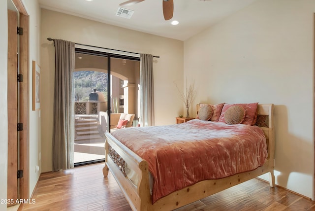 bedroom featuring access to exterior, ceiling fan, and light hardwood / wood-style flooring