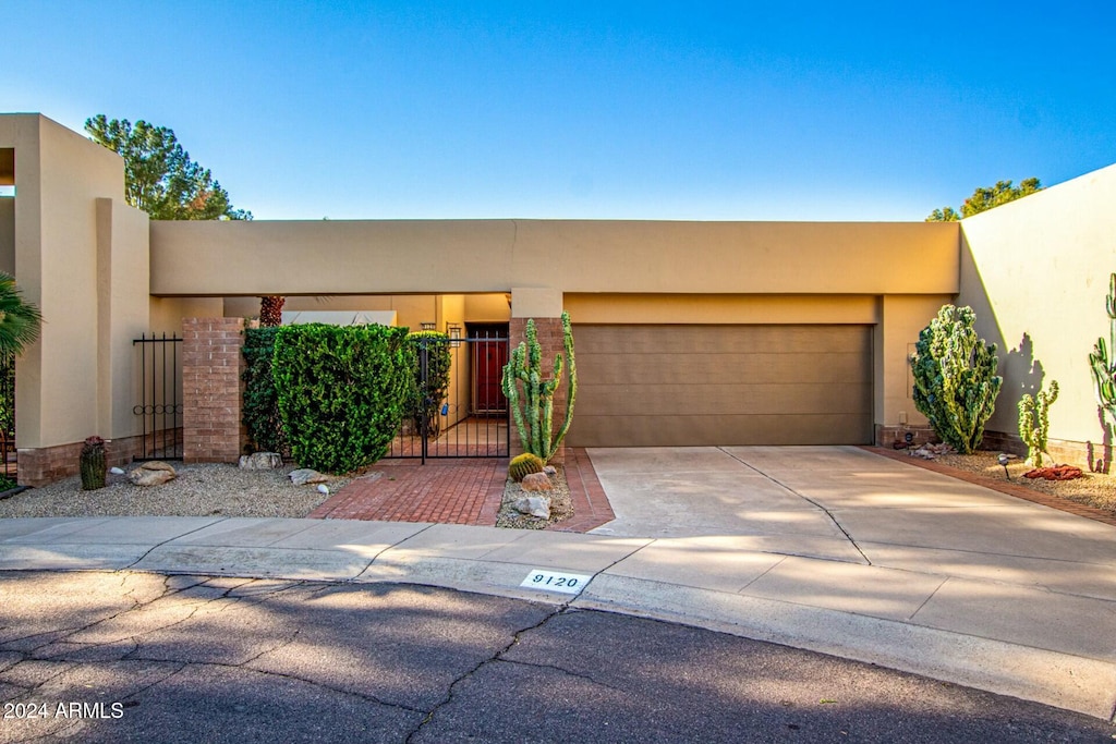 pueblo-style house featuring a garage