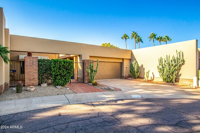 pueblo-style house with a garage