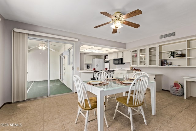 dining room with light tile patterned floors, ceiling fan, and visible vents