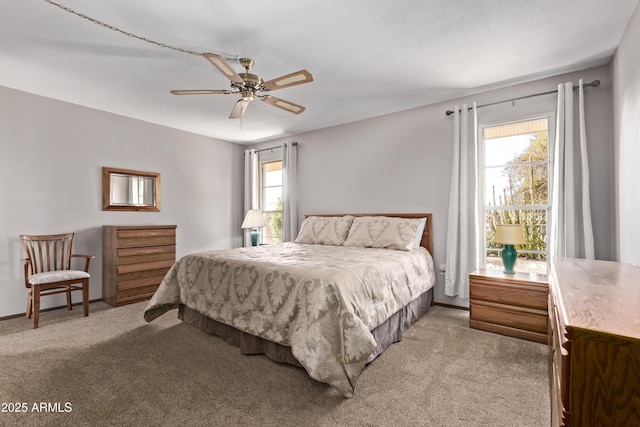 bedroom featuring ceiling fan and light colored carpet