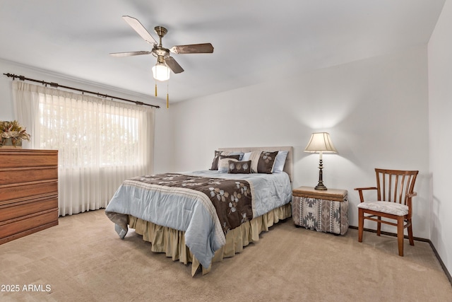 bedroom with light carpet, ceiling fan, and baseboards