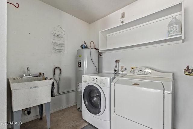 laundry room with laundry area, water heater, and separate washer and dryer