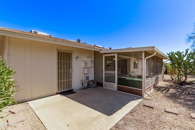 view of exterior entry featuring a patio