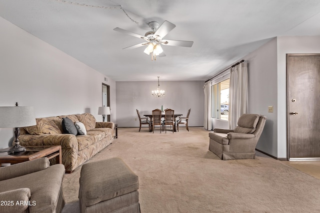 living room with light colored carpet and ceiling fan with notable chandelier