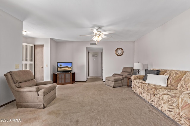 living area featuring visible vents, ceiling fan, and light carpet