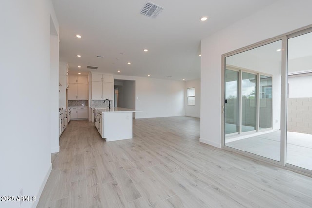 1246 E Penedes Dr, Gilbert, AZ 85298 - unfurnished living room with recessed lighting and light wood-style floors
