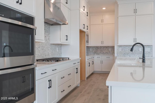 1246 E Penedes Dr, Gilbert, AZ 85298 - kitchen featuring wall chimney range hood, appliances with stainless steel finishes, light countertops, white cabinetry, and recessed lighting