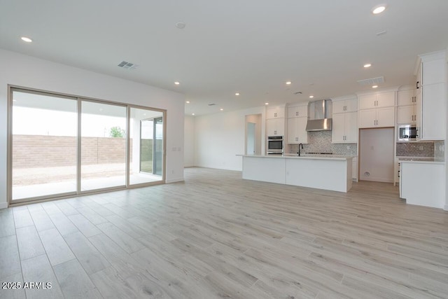 1246 E Penedes Dr, Gilbert, AZ 85298 - unfurnished living room with light wood-type flooring, recessed lighting, and baseboards