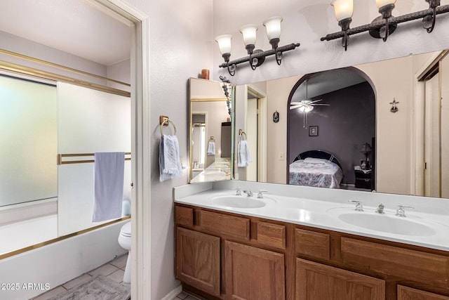 ensuite bathroom with a sink, double vanity, combined bath / shower with glass door, and connected bathroom