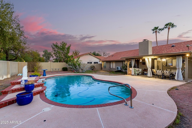 view of swimming pool featuring a patio, a fenced backyard, and a fenced in pool