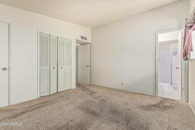 5420 N Granite Reef Rd, Scottsdale, AZ 85250 - unfurnished bedroom featuring carpet flooring, a closet, a textured ceiling, and connected bathroom
