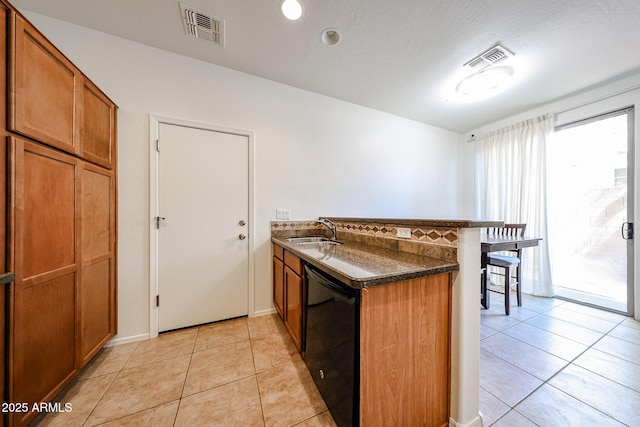 451 S Hawes Rd Unit 53, Mesa, AZ 85208 - kitchen with a peninsula, a sink, black dishwasher, brown cabinets, and a breakfast bar