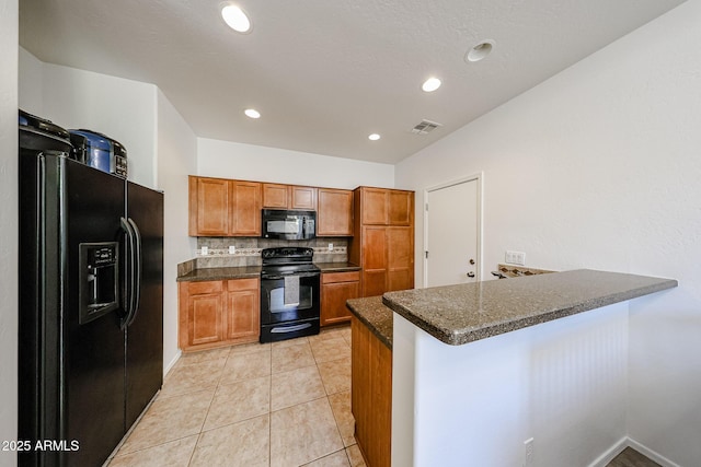 451 S Hawes Rd Unit 53, Mesa, AZ 85208 - kitchen featuring black appliances, dark countertops, a peninsula, brown cabinets, and backsplash