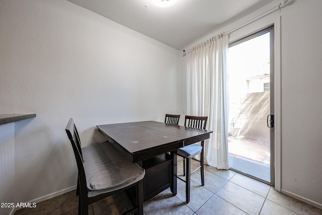 451 S Hawes Rd Unit 53, Mesa, AZ 85208 - dining room featuring baseboards, light tile patterned floors, and lofted ceiling
