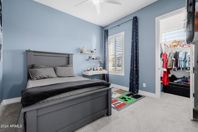 carpeted bedroom with ceiling fan and a closet