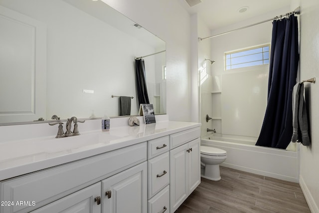 full bathroom with shower / bath combo, vanity, hardwood / wood-style flooring, and toilet