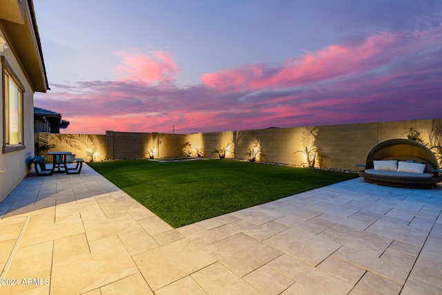 yard at dusk with a patio