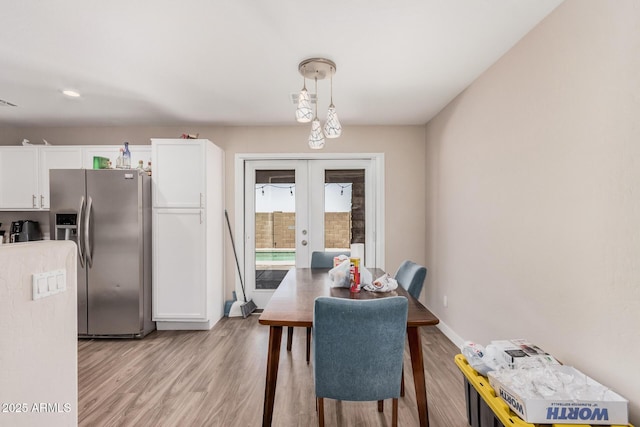 2516 E San Manuel Rd, San Tan Valley, AZ 85143 - dining space with french doors and light wood-style floors
