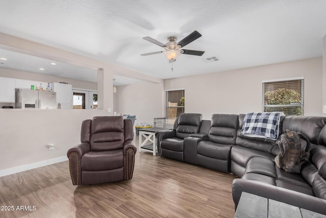 2516 E San Manuel Rd, San Tan Valley, AZ 85143 - living room with ceiling fan, wood finished floors, healthy amount of natural light, and recessed lighting