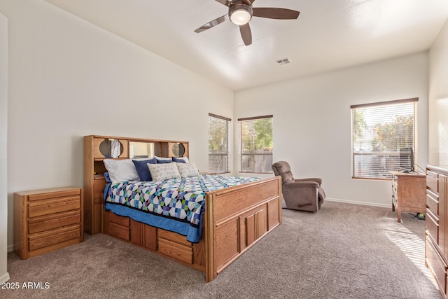 carpeted bedroom with visible vents, baseboards, and a ceiling fan