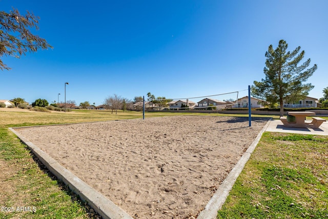 view of property's community featuring a yard, volleyball court, and a residential view