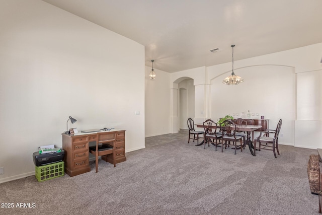 carpeted dining space featuring arched walkways, visible vents, and baseboards