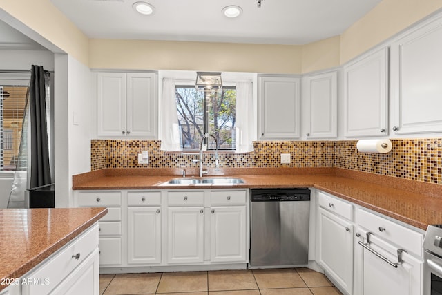 kitchen featuring stainless steel dishwasher, sink, and white cabinets