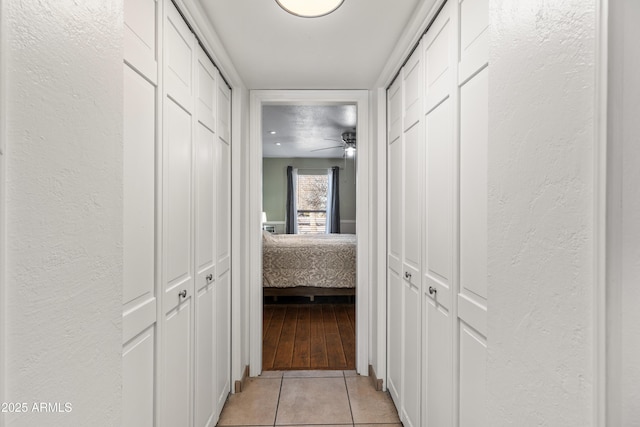 hall with light tile patterned floors