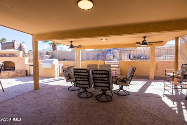 view of patio with ceiling fan and an outdoor stone fireplace