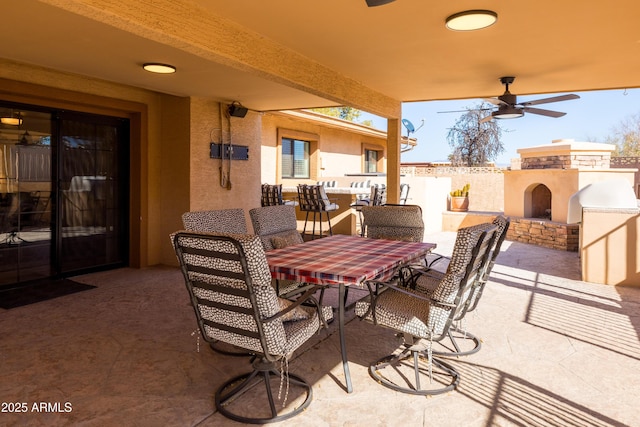 view of patio / terrace featuring an outdoor fireplace and ceiling fan