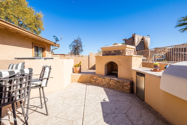 view of patio / terrace with an outdoor stone fireplace