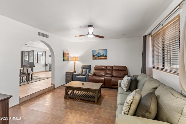 living room with wood-type flooring and ceiling fan