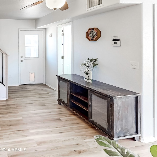 entrance foyer with ceiling fan and light hardwood / wood-style flooring