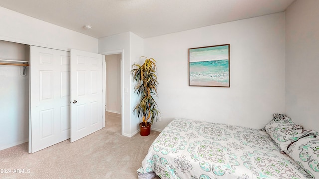 bedroom with light colored carpet and a closet