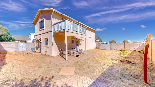 rear view of house featuring a patio