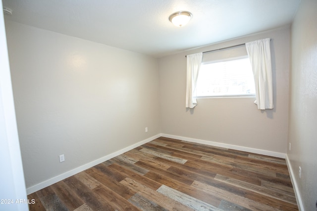 spare room featuring dark hardwood / wood-style flooring