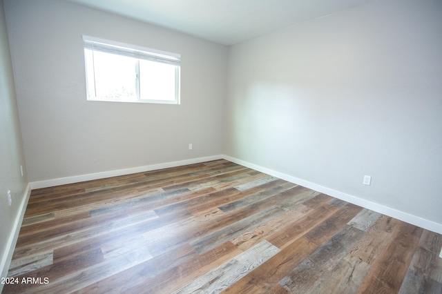 empty room with dark hardwood / wood-style floors