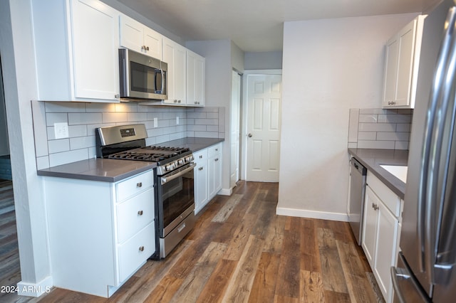 kitchen featuring white cabinets, dark wood-type flooring, and appliances with stainless steel finishes