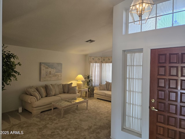 foyer with carpet floors, a chandelier, and plenty of natural light